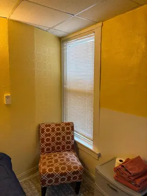 a room with a chair and a window at Private tiny room for one in Cincinnati