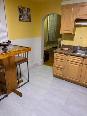 a kitchen with wooden cabinets and a counter top at Private tiny room for one in Cincinnati