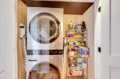 a kitchen with a washer and dryer in a room at 1 Mi to Marina Cabin with Views Near Atwood Lake! in Dellroy