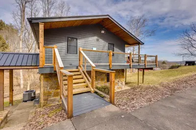 a house with a staircase leading up to it at 1 Mi to Marina Cabin with Views Near Atwood Lake! in Dellroy