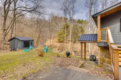 a house with a yard with a shed at 1 Mi to Marina Cabin with Views Near Atwood Lake! in Dellroy