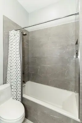 a bathroom with a toilet and a tub and a shower at Luxury 4BR - Washington Park - Walk Everywhere in Cincinnati
