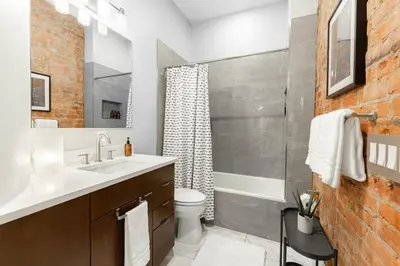 a bathroom with a sink and a toilet and a shower at Luxury 4BR - Washington Park - Walk Everywhere in Cincinnati