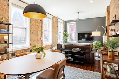 a living room with a table and a couch at Luxury 4BR - Washington Park - Walk Everywhere in Cincinnati