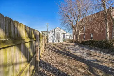 a wooden fence in front of a house at Charming Getaway on Ash St- Minutes from Cinci in Ludlow