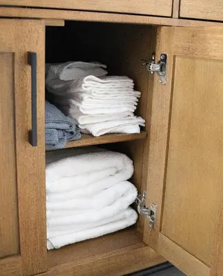 a cabinet filled with lots of white towels at Little Gem in Millersburg