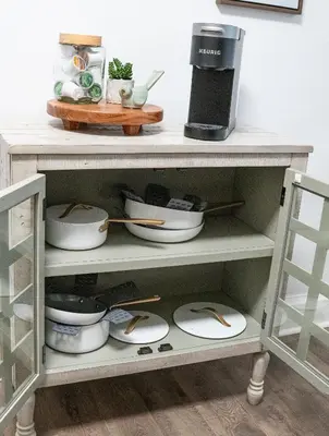 a shelf with bowls and utensils on it at Little Gem in Millersburg