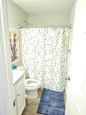 a bathroom with a toilet and a shower curtain at Amazing New Wilmington Ranch in Wilmington