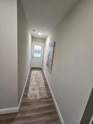 a hallway with white walls and a white door at Amazing New Wilmington Ranch in Wilmington