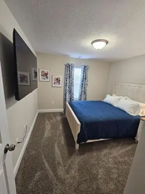 a bedroom with a bed and a television in it at Cute New Const Wilmington Ranch in Wilmington