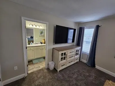 a bathroom with a sink and a tv and a mirror at Cute New Const Wilmington Ranch in Wilmington