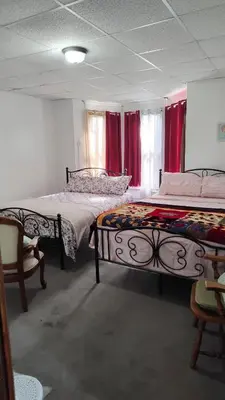 two beds in a room with red curtains at Valley and city views in Steubenville