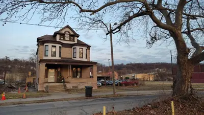 a small house with a clock on it on a street at Valley and city views in Steubenville