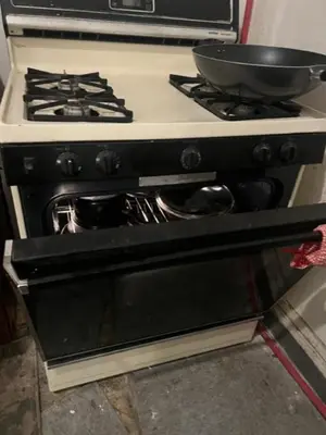 a stove with a frying pan on top of it at Valley and city views in Steubenville