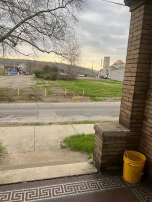 a building with a yellow bucket next to a street at Valley and city views in Steubenville