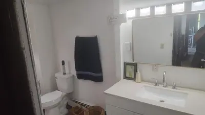 a bathroom with a toilet and a sink and a mirror at Valley and city views in Steubenville