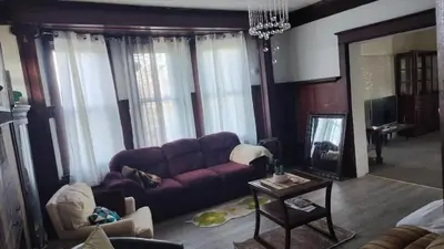 a living room with a purple couch and a table at Valley and city views in Steubenville