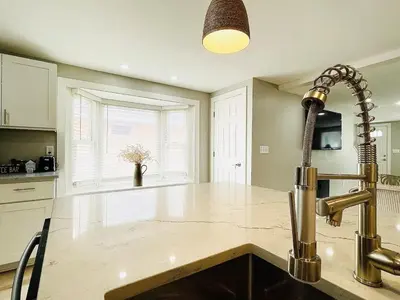 a kitchen with a sink and a faucet at Pink Bungalow Downtown in Sandusky