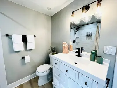 a bathroom with a white sink and a toilet at Pink Bungalow Downtown in Sandusky