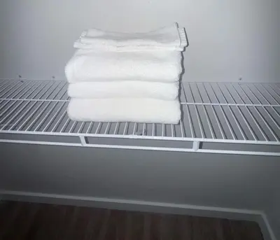 a stack of towels on a shelf in a refrigerator at Bright & Cozy Near TQL & Paycor Stadiums in Cincinnati
