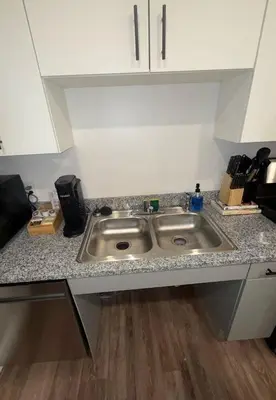 a kitchen counter with a stainless steel sink at Bright & Cozy Near TQL & Paycor Stadiums in Cincinnati