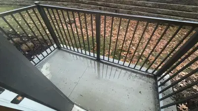 an overhead view of a metal fence with water on the ground at Bright & Cozy Near TQL & Paycor Stadiums in Cincinnati
