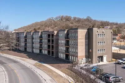 an apartment building on the side of a road at Bright & Cozy Near TQL & Paycor Stadiums in Cincinnati