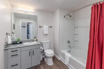 a bathroom with a white toilet and a tub and a sink at Bright & Cozy Near TQL & Paycor Stadiums in Cincinnati