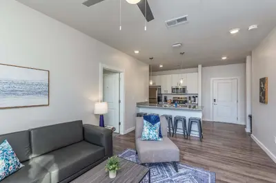 a living room with a couch and a kitchen at Stylish & Spacious Stay Near The Banks in Cincinnati