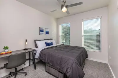 a bedroom with a bed and a desk and a computer at Stylish & Spacious Stay Near The Banks in Cincinnati
