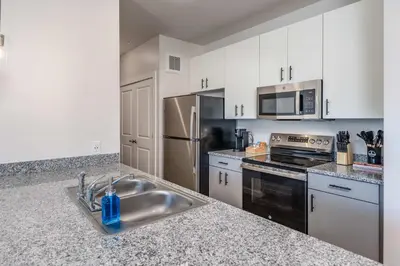 a kitchen with stainless steel appliances and a sink at Stylish & Spacious Stay Near The Banks in Cincinnati