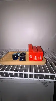 a shelf on top of a refrigerator with red books at Stylish & Spacious Stay Near The Banks in Cincinnati