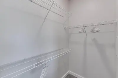 a white bathroom with white walls and a shelf at Modern Stay Close to Dining & Entertainment in Cincinnati