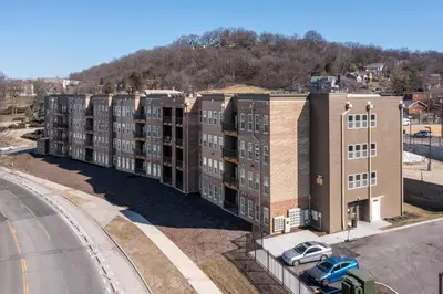 an apartment building with a car parked in front of it at Modern Stay Close to Dining & Entertainment in Cincinnati