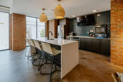 a kitchen with a kitchen island with bar chairs at OTR 1 Bed Suite Free Parking Gym Pool Clubroom in Cincinnati