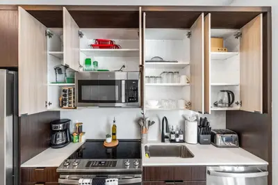 a kitchen with a sink and a microwave at OTR 1 Bed Suite Free Parking Gym Pool Clubroom in Cincinnati