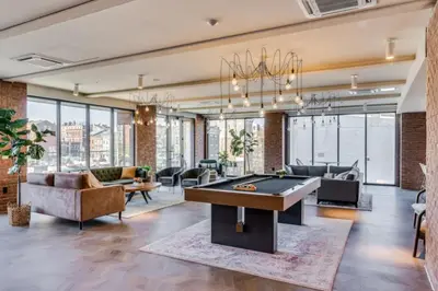 a living room with a pool table in the middle at OTR 1 Bed Suite Free Parking Gym Pool Clubroom in Cincinnati