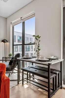 a dining room with a table and a large window at OTR King Bed Free Parking Gym Top Floor Club Room in Cincinnati