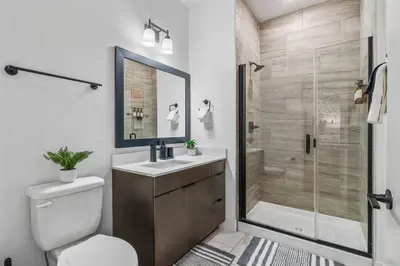 a bathroom with a shower and a toilet and a sink at OTR King Bed Free Parking Gym Top Floor Club Room in Cincinnati