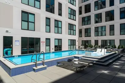 a swimming pool in front of a building at OTR King Bed Free On Site Parking Gym Pool Club Room in Cincinnati