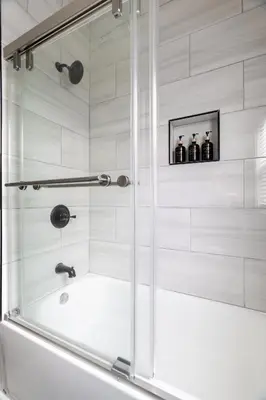 a bathroom with a shower with a bath tub at Luxury Short and Midterm Hyde Park Getaway in Cincinnati