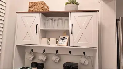 a kitchen with white cupboards with coffee mugs at Luxury Short and Midterm Hyde Park Getaway in Cincinnati