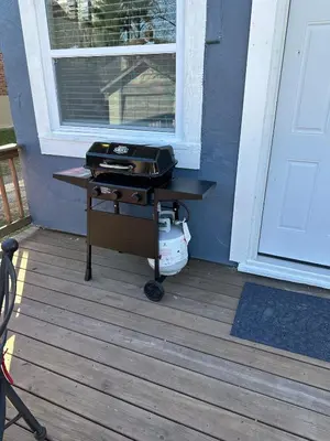 a grill sitting on a porch next to a door at Luxury Short and Midterm Hyde Park Getaway in Cincinnati