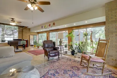 a living room with a bed and a piano at Spacious and Updated Farmhouse in Yellow Springs in Fairborn