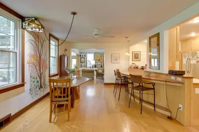 a kitchen and living room with a table and chairs at Spacious and Updated Farmhouse in Yellow Springs in Fairborn