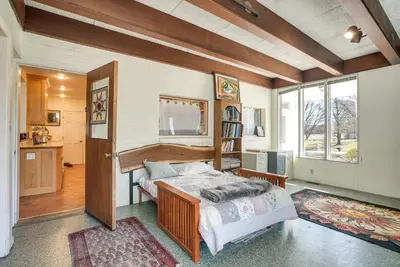 a bedroom with a bed and a large window at Spacious and Updated Farmhouse in Yellow Springs in Fairborn