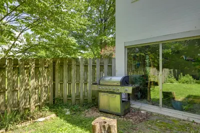 a grill in a yard next to a fence at Spacious and Updated Farmhouse in Yellow Springs in Fairborn