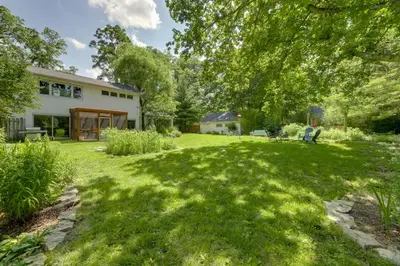 a yard with green grass and a house at Spacious and Updated Farmhouse in Yellow Springs in Fairborn