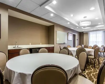 a conference room with a white table and chairs at Comfort Suites-Youngstown North in Youngstown