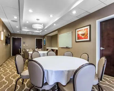 a conference room with a white table and chairs at Comfort Suites-Youngstown North in Youngstown